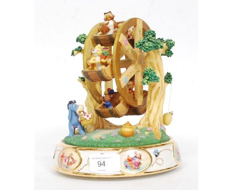 A ceramic Winnie The Pooh novelty musical Ferris wheel bearing notation to the base. H24 cm 