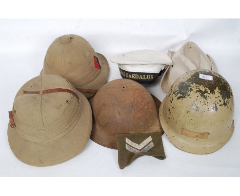 A collection of vintage military army and naval helmets to include tropical issue, 2nd world war, Hms Daedalus naval etc