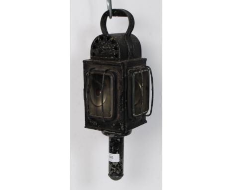 A vintage ebonised metal railway guards lamp having bevelled glass lenses with wick to inside