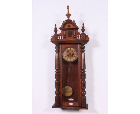A 19th century large walnut cased vienna regulator wall clock in the manner of Gustav Becker. This large example with enamel 
