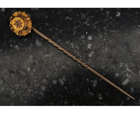 A 15ct gold vintage stick pin with inset diamond to the flowerhead top. 1.5g