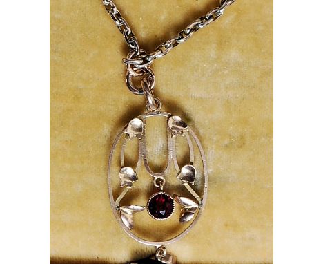A 9ct gold gold box chain and ruby garnet stone pendant, circa early 20th century Art Nouveau. The pendant and chain both mar