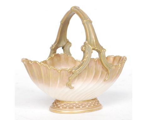 A Royal Worcester Ivory Blush bon bon dish basket of scalloped form with handle. Puce mark to base with Rd No 161527 - 1483