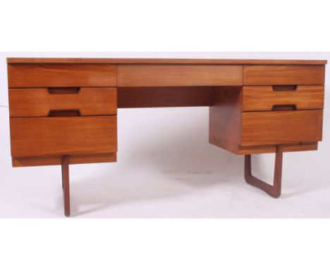 A vintage 1960's Uniflex retro teak wood writing table desk raised on angular supports with series of drawers either side of 