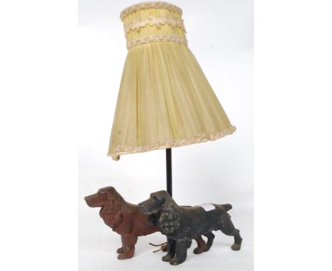 An unusual mid 20th century table lamp adorned with cast metal spaniels with central stem and shade atop. H40 cm 
