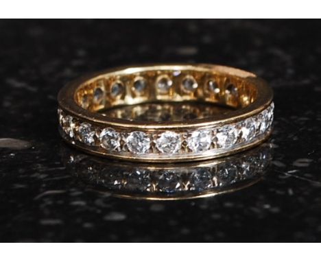 An 18ct gold eternity ring with inset channel diamonds approx .50pnts. Weight 4g