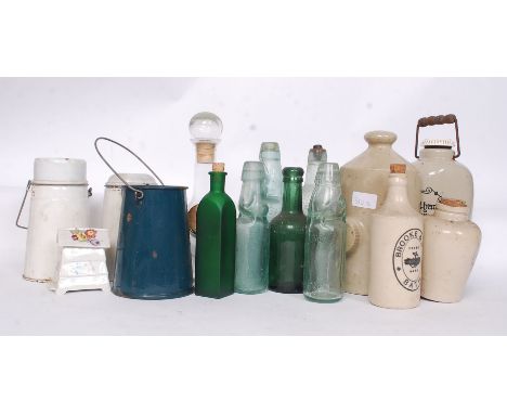 A collection of stoneware and glass  advertising bottles with many local examples along with enamel billy cans etc