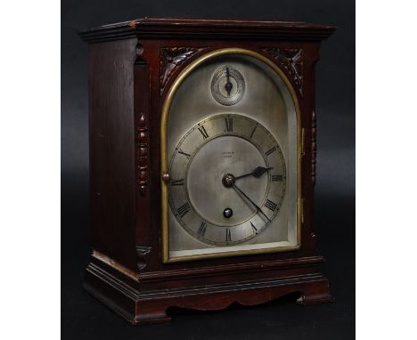 An early 20th century Harrods of London bracket mantel clock. Set in a mahogany case with silvered dial having brass movement
