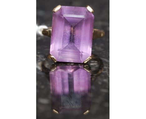 A 9ct gold and amethyst ladies dress / cocktail ring. The large cushion cut amethyst being claw mounted. Ring size O/P 5.2g