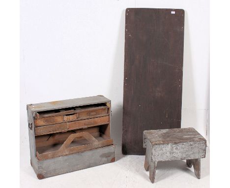 A retro ex military dispersal table together with a carpenters stool and open sectional toolbox / shelf