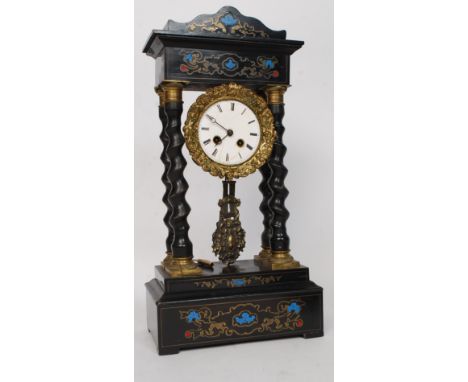 A mid 19th century French Portico clock having and architectural canopy inlaid with foliate designs above a gilt metal framed