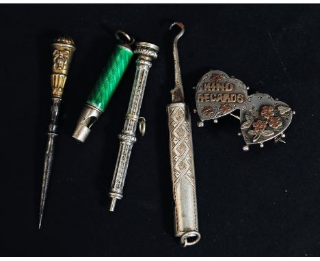 A collection of silver and white metal items to include a propelling pencil, enamel set whistle twin heart silver and gold br