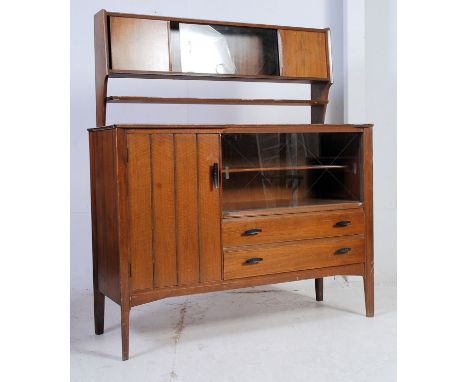 A vintage 1950's retro Lebus cabinet sideboard being raised on angled legs with cupboards and drawers under upright gallery b