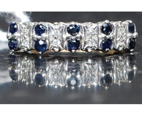 A 9ct gold, diamond and sapphire channel set ring. The central stones approx 1pnts each. Ring  size L 2.6g