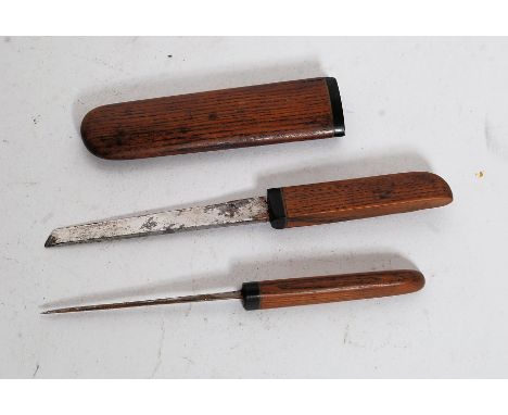 An unusual wood and horn mounted oriental eating set comprising knife and spike in scabbard.