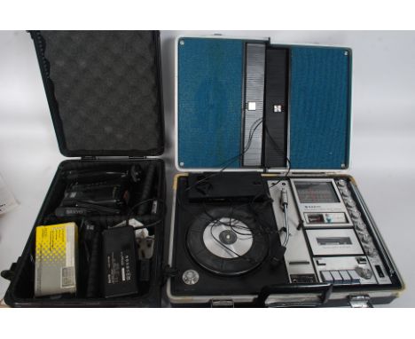 A 1970's retro Sanyo portable stereo music centre G-2615H. Set within briefcase style case with inset fold out speakers. Toge
