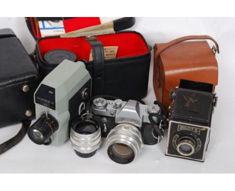 A good vintage Zenit SLR camera together with a collection of lenses and accessories in leather carry bag. Also a cine camera