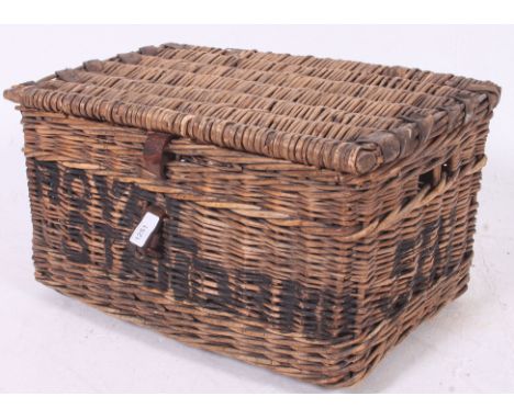 A vintage early 20th century whicker hamper / basket having animal hide straps  with notation to the front ROYAL STANDARD and