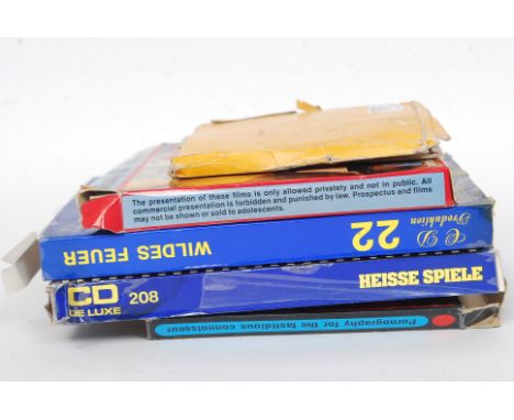 A collection of vintage 8mm adult pornographic films, each within the original box.