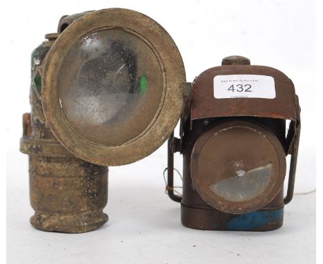A vintage ARP hand held black out lamp together with a good motorcycle Lucas lamp