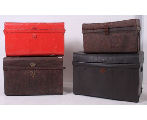 A stack of early 20th century vintage metal trunks to include graduating sizes, one in red etc ( 4 total )