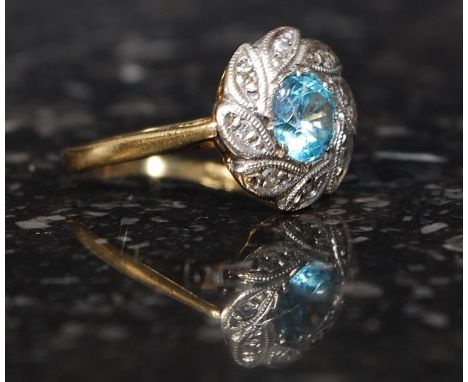 A Ladies 18ct gold and diamond dress ring with round cut cornflower blue stone. Approx 2.9g