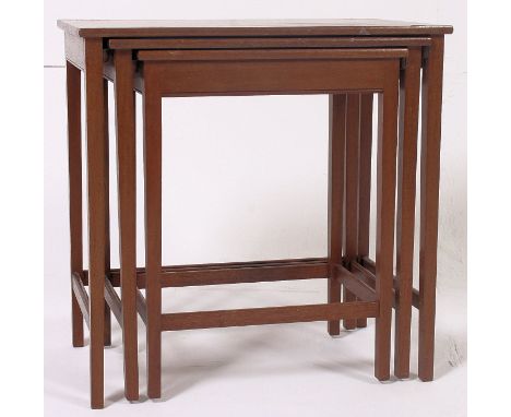 A retro vintage 1950's teak nest of tables raised on squared legs with graduating tops. 