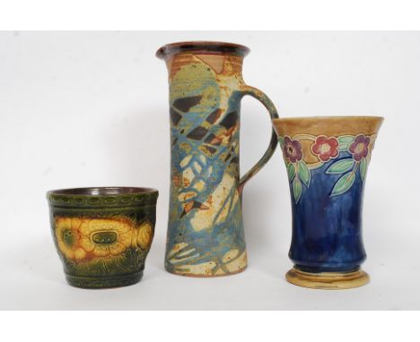 An early 20th century Royal Doulton painted vase, with impressed mark to base along with two other ceramic vases - the first 