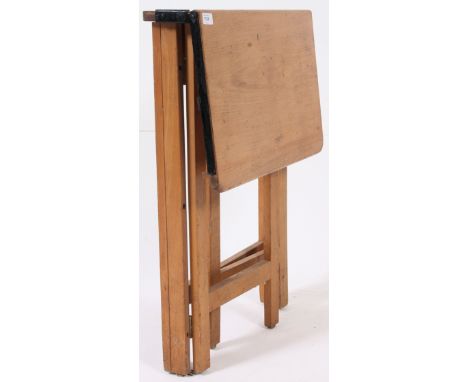 A 1950's folding school desk. Raised on swing gate legs with sloped desk top with hinged lid and well. H77 x W57 x D47cm 