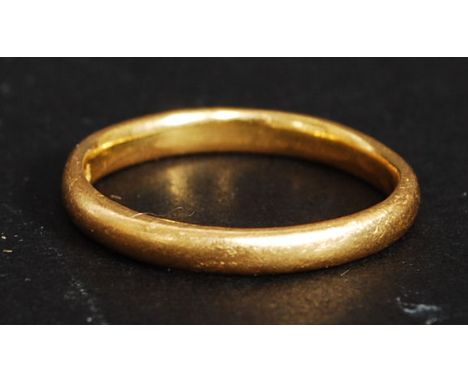 A 22ct gold plain wedding band, with hallmarks to the inner ring. 3.4g  RS M/N