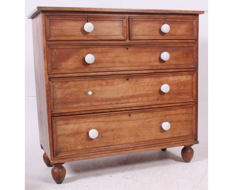 A Victorian stripped mahogany 2 over 3 chest of drawers. The chest on bun feet with 2 short over 3 graduating drawers having 