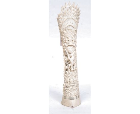 A carved bone figural statue, depicting a Chinese figure to centre. H25 cm 