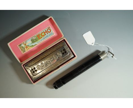 A cased Hohner "The Echo Harp" harmonica and a Swanee whistle