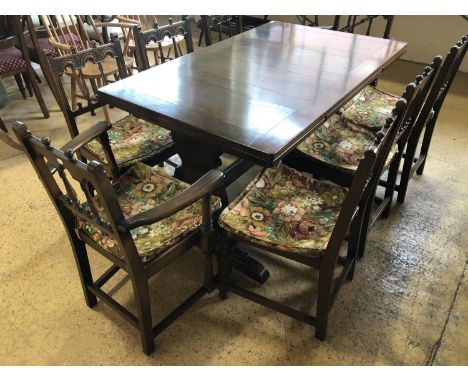 Eight Ercol dining chairs together with a draw-leaf table