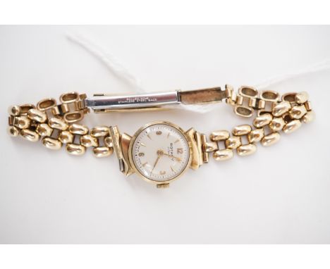 A lady's 9ct gold cased Rotary wristwatch, with circular silvered dial, dagger and Arabic numerals, and a rolled-gold bracele