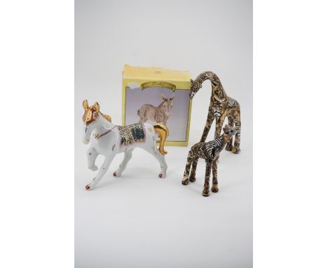 Animal figurines including a boxed Leonardo Collection donkey, a ceramic circus horse, and two contemporary composition giraf