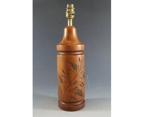 A carved wooden lamp base