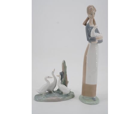 Two Nao figurines, a girl with goose, and geese