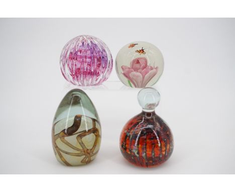 A Caithness "Optix" paperweight, together others including Mdina