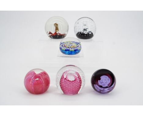 Six Caithness paperweights including "Twirl", "White Rose", "Moonflower", "Seagems", "Cauldron" and two others