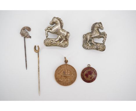 A 1911 Greenock Royal commemorative medallion, a Hebrew fob horseshoe stick pin and two 19th Century horse tack decorative mo