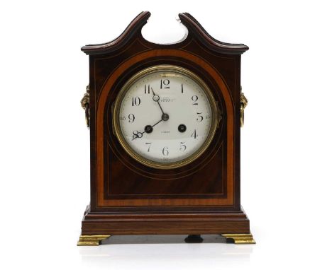 An Edwardian mahogany crossbanded mantle clock, 20th century, with a convex enamelled dial, French Mougin movement, striking 