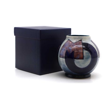 A Moorcroft pottery vase decorated with Art Deco style letters spelling 'Moorcroft', impressed and painted marks, in its orig