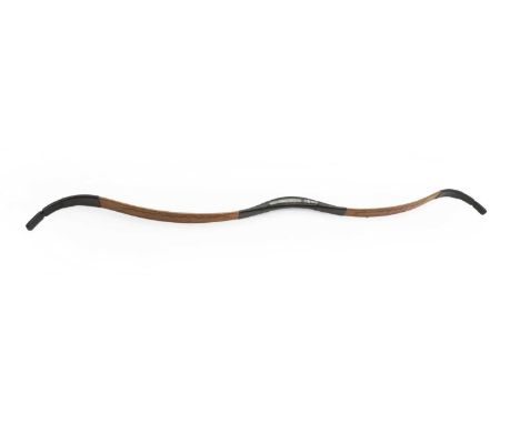 An eastern bow with leather covering 20th century, 128cm longa parang, 19th century with bound hilt, blade 47cm long  62cm lo