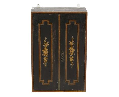 A lacquered hanging cabinet  early 19th century, the twin panelled doors deorated in gilt with fruiting swags 40cm wide   22c