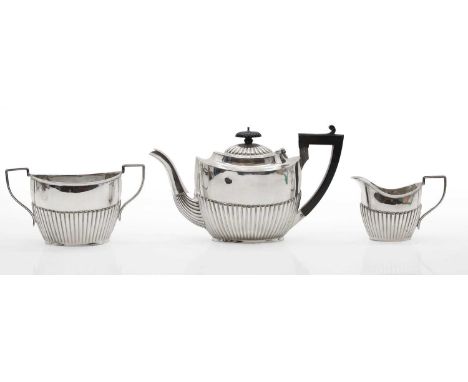 An Edwardian composed silver three piece tea-service, the teapot by George Nathan &amp; Ridley Hayes, Chester 1914, the cream