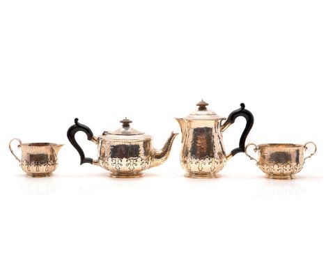 A four-piece silver tea service, probably by Charles Edwards, London 1920, comprising a teapot, hot water pot, wooden finials