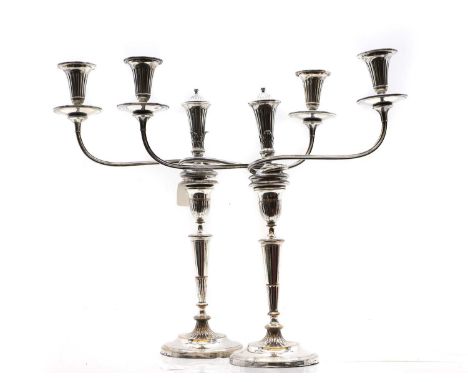 A pair of silver plated candelabra of typical form, with two sconces, on flaring stems, with crests to bases,45.5cm high (2)C