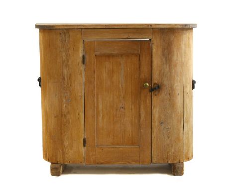 A pine cabinet,  19th century, with a single paneled cupboard door raised on sledge feet, no back,   103cm wide   34cm deep  