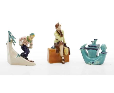 A Goebel ceramic figure of a lady seated on a suitcase, 1930s,18.5cm high, an Italian figure of a skier,in the manner of Lenc